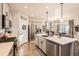 Well-lit kitchen features stainless steel appliances, kitchen island, and hardwood floors at 222 Fox St, Bennett, CO 80102