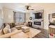Cozy living room with a fireplace, ceiling fan, and stylish decor, creating a relaxing atmosphere at 222 Fox St, Bennett, CO 80102