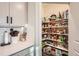 This walk-in pantry provides organized storage for groceries, kitchen essentials, and appliances, ensuring a clutter-free kitchen at 222 Fox St, Bennett, CO 80102