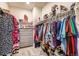 Well-organized walk-in closet with clothing racks, shelves, and soft carpet at 222 Fox St, Bennett, CO 80102