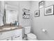 Bathroom with vanity, toilet, wall decor, and a light grey color scheme at 3103 W 18Th Ave, Denver, CO 80204