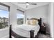 Bright bedroom featuring a dark wood bed frame, neutral walls, and many windows at 3103 W 18Th Ave, Denver, CO 80204