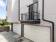 Modern exterior with multiple garage doors and a small balcony space at 3103 W 18Th Ave, Denver, CO 80204