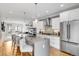 Modern kitchen with quartz island, white cabinets, stainless appliances, and wood floors at 3103 W 18Th Ave, Denver, CO 80204