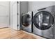 Laundry room with hardwood floors and stainless steel washer and dryer at 3103 W 18Th Ave, Denver, CO 80204