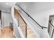 Modern staircase with neutral walls, hardwood flooring, and black iron railing at 3103 W 18Th Ave, Denver, CO 80204