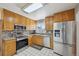 Updated kitchen with stainless steel appliances, tile backsplash, and plenty of cabinet space for storage at 1001 S Nucla St, Aurora, CO 80017