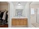 Bright main bathroom featuring wood cabinets, dual access, and separate shower at 1001 S Nucla St, Aurora, CO 80017