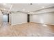 Finished basement with laminate flooring and neutral paint at 2816 Greensborough Dr, Highlands Ranch, CO 80129