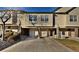 Charming exterior view of townhome with attached garages, brick accents, and well-maintained landscaping at 1785 Morrison Ct, Superior, CO 80027