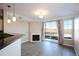 Open floorplan living room with fireplace, access to a patio, and plenty of natural light at 1785 Morrison Ct, Superior, CO 80027