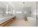 Bright bathroom featuring double sinks, modern fixtures, and a luxurious soaking tub near large window at 318 Adams St, Denver, CO 80206