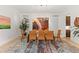 Well-lit dining room showcasing a glass-top table with unique light fixture and colorful artwork at 318 Adams St, Denver, CO 80206