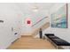 Bright entryway featuring hardwood floors, white walls, and a modern light fixture at 318 Adams St, Denver, CO 80206