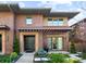 Inviting brick home showcasing a pergola, manicured landscaping and covered entryway at 318 Adams St, Denver, CO 80206