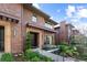 Elegant exterior elevation featuring brick facade, pergola over entry, beautiful landscaping, and a walkway to the front door at 318 Adams St, Denver, CO 80206