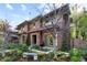 Two story brick home features manicured landscaping and a charming bench out front at 318 Adams St, Denver, CO 80206