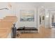 Bright foyer with wooden floors, a modern bench, and stairs leading to the upper level at 318 Adams St, Denver, CO 80206