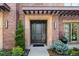 Charming front entrance with a stately dark door, a brick facade, manicured landscaping, and elegant outdoor lighting at 318 Adams St, Denver, CO 80206