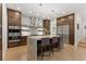 Elegant kitchen features wood cabinets, stainless steel appliances, and a marble waterfall island with seating at 318 Adams St, Denver, CO 80206