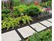 Stone walkway through a beautiful garden featuring multiple flower species, plants, greenery and professional landscaping at 318 Adams St, Denver, CO 80206