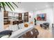 Open concept living room showcasing hardwood floors and an adjacent kitchen with stainless appliances at 318 Adams St, Denver, CO 80206