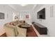 Bright living room boasts neutral tones, decorative ceilings, and a unique curved sofa, perfect for stylish relaxation and entertaining at 318 Adams St, Denver, CO 80206