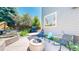 Relaxing backyard with a fire pit, mature trees, and various seating options at 4826 S Ireland St, Aurora, CO 80015