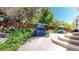 Relaxing backyard patio features a swing and outdoor dining area surrounded by lush landscaping and a privacy fence at 4826 S Ireland St, Aurora, CO 80015