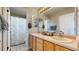 Well-lit bathroom featuring double sinks and a tub and shower combo at 4826 S Ireland St, Aurora, CO 80015