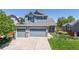 Beautiful two-story home boasts a three-car garage and well-manicured lawn and landscaping for great curb appeal at 4826 S Ireland St, Aurora, CO 80015