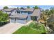 Stunning two-story home with a three-car garage, lush lawn, and beautiful landscaping creates a welcoming exterior at 4826 S Ireland St, Aurora, CO 80015