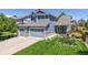 Charming blue two-story home with a manicured lawn and a three-car garage offering great curb appeal at 4826 S Ireland St, Aurora, CO 80015