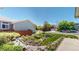 Well-manicured front yard features lush landscaping, decorative rocks, and a charming walkway leading to the home at 4826 S Ireland St, Aurora, CO 80015