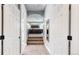 Hallway view leading into the main bedroom with carpeted floor and neutral colored walls at 4826 S Ireland St, Aurora, CO 80015