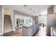Open-concept kitchen features a granite island, stainless steel appliances, and connects to the living room with a fireplace at 4826 S Ireland St, Aurora, CO 80015