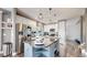 Bright kitchen boasts a large island, granite counters, stainless appliances, and a view of the staircase at 4826 S Ireland St, Aurora, CO 80015