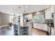 Modern kitchen featuring a large island with granite countertops, stainless steel appliances, and hardwood floors at 4826 S Ireland St, Aurora, CO 80015
