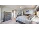 Comfortable main bedroom with neutral decor, arched architecture, soft carpet, and ceiling fan at 4826 S Ireland St, Aurora, CO 80015