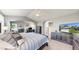 Spacious main bedroom featuring a sitting area, large bed, carpet flooring, and natural light at 4826 S Ireland St, Aurora, CO 80015