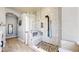 Luxurious marble shower with mosaic floor, bench seat, and modern fixtures in a well-lit bathroom at 4826 S Ireland St, Aurora, CO 80015