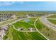 Aerial view of community park featuring playground, tennis courts, walking path, and community with road access at 9350 Dunraven St, Arvada, CO 80007