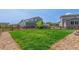 Spacious backyard featuring a well-maintained lawn and classic wood fence at 9350 Dunraven St, Arvada, CO 80007