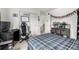 Bedroom with a double bed, a desk with a computer, a chair, doors, a flag banner, and a small basketball hoop at 9350 Dunraven St, Arvada, CO 80007