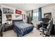 Bedroom with a double bed, a large window, posters on the wall, a basketball hoop, a black desk, and a chair at 9350 Dunraven St, Arvada, CO 80007
