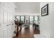 Welcoming entryway featuring hardwood floors, open staircase, and an open-concept layout to the living spaces at 9350 Dunraven St, Arvada, CO 80007