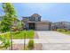 Beautiful two-story home with stone accents, well-manicured lawn, and a two-car garage at 9350 Dunraven St, Arvada, CO 80007