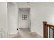 Upstairs hallway showcasing neutral carpet, wood railing, and access to multiple rooms at 9350 Dunraven St, Arvada, CO 80007
