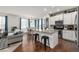 Open-concept kitchen, dining, and living area with hardwood floors and modern finishes at 9350 Dunraven St, Arvada, CO 80007