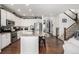 Modern kitchen has stainless appliances, granite counters, and connects the dining and living areas at 9350 Dunraven St, Arvada, CO 80007